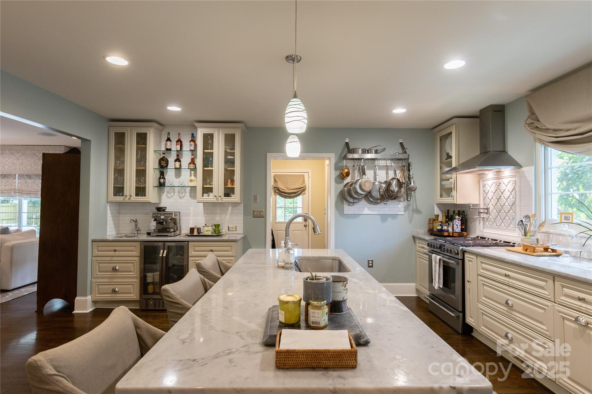802 East Franklin Street Monroe, NC 28112 - Photo 21 of 48 a kitchen with stainless steel appliances granite countertop a stove top oven a sink a dining table and chairs with wooden floor