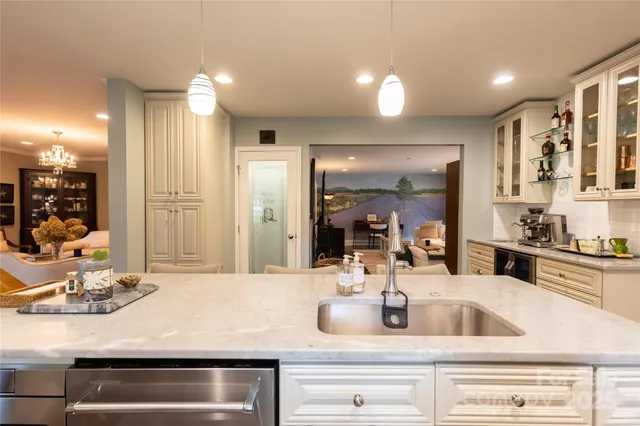 a kitchen with kitchen island a sink stainless steel appliances and cabinets