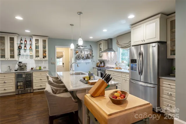 a kitchen with stainless steel appliances a stove a sink and a refrigerator