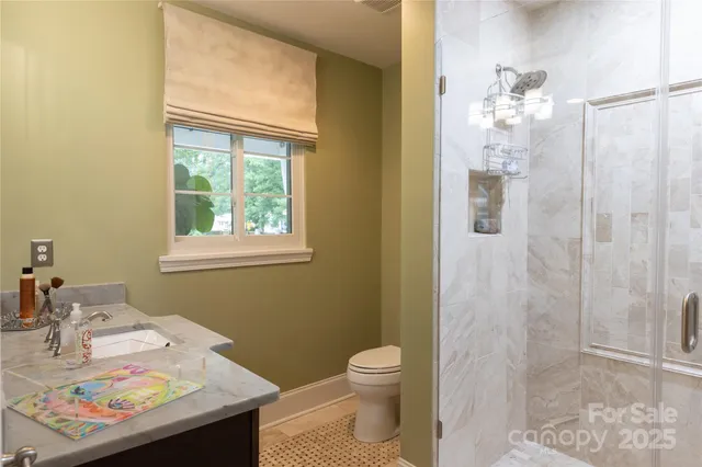 a bathroom with a sink vanity granite and toilet