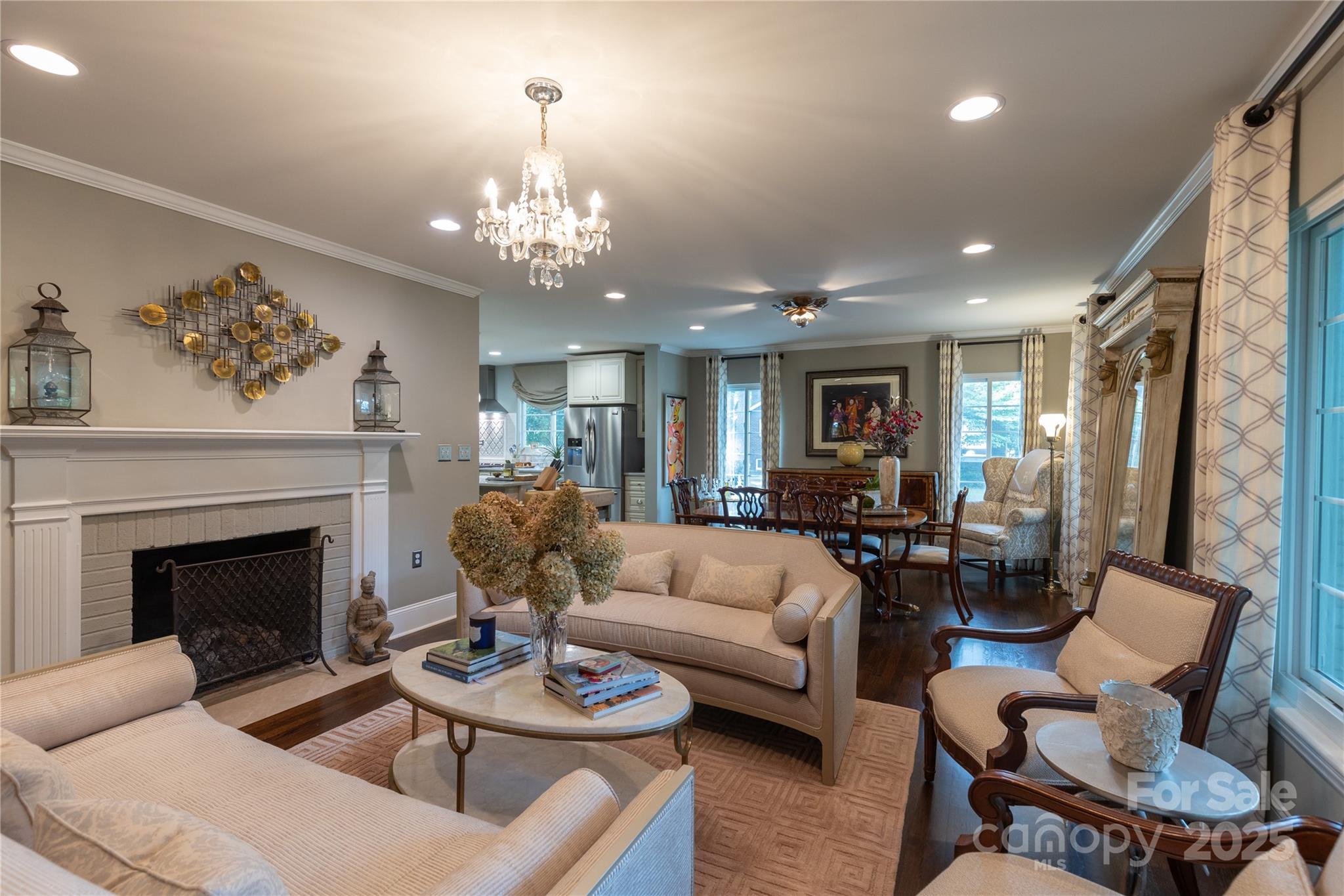 802 East Franklin Street Monroe, NC 28112 - Photo 4 of 48 a living room with furniture a fireplace and a chandelier