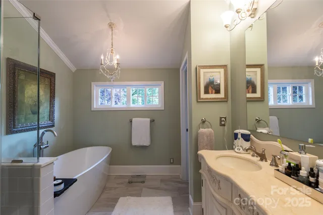 a bathroom with a tub a sink and mirror