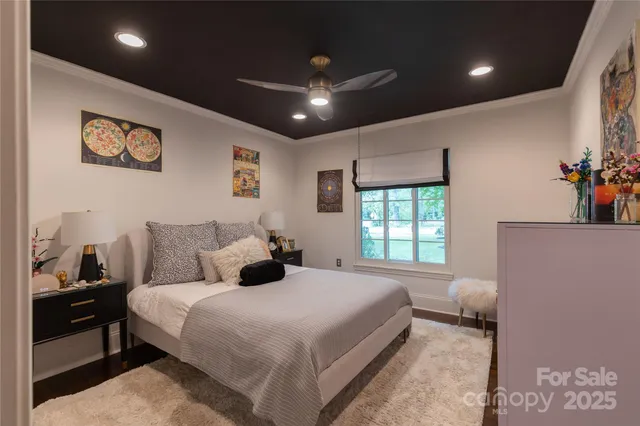 a bedroom with a large bed and a large window