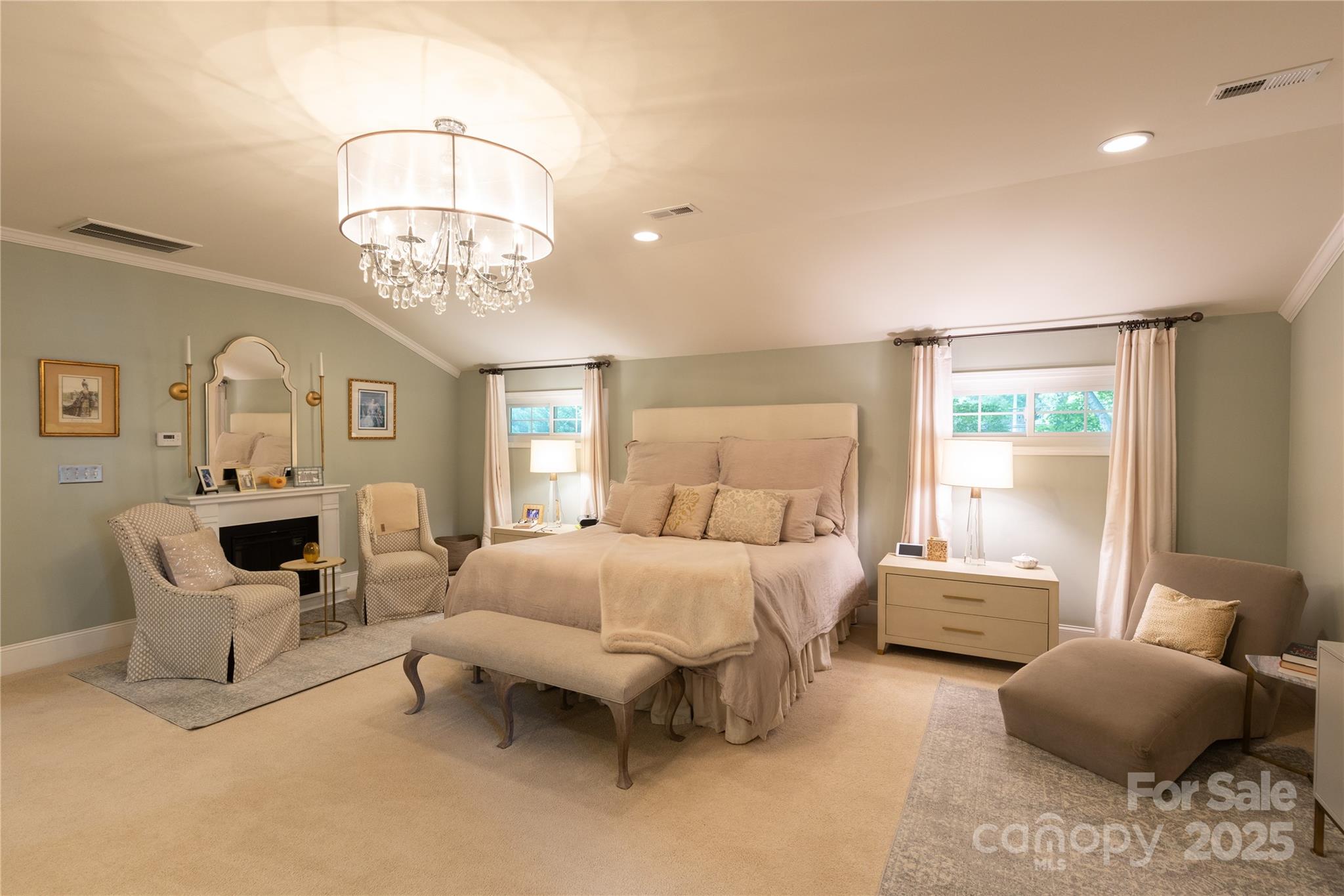 802 East Franklin Street Monroe, NC 28112 - Photo 10 of 48 a spacious bedroom with a bed and a chandelier