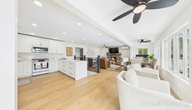 a living room with furniture a fireplace and a flat screen tv