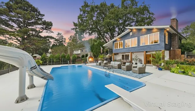 an aerial view of a house with swimming pool garden and patio