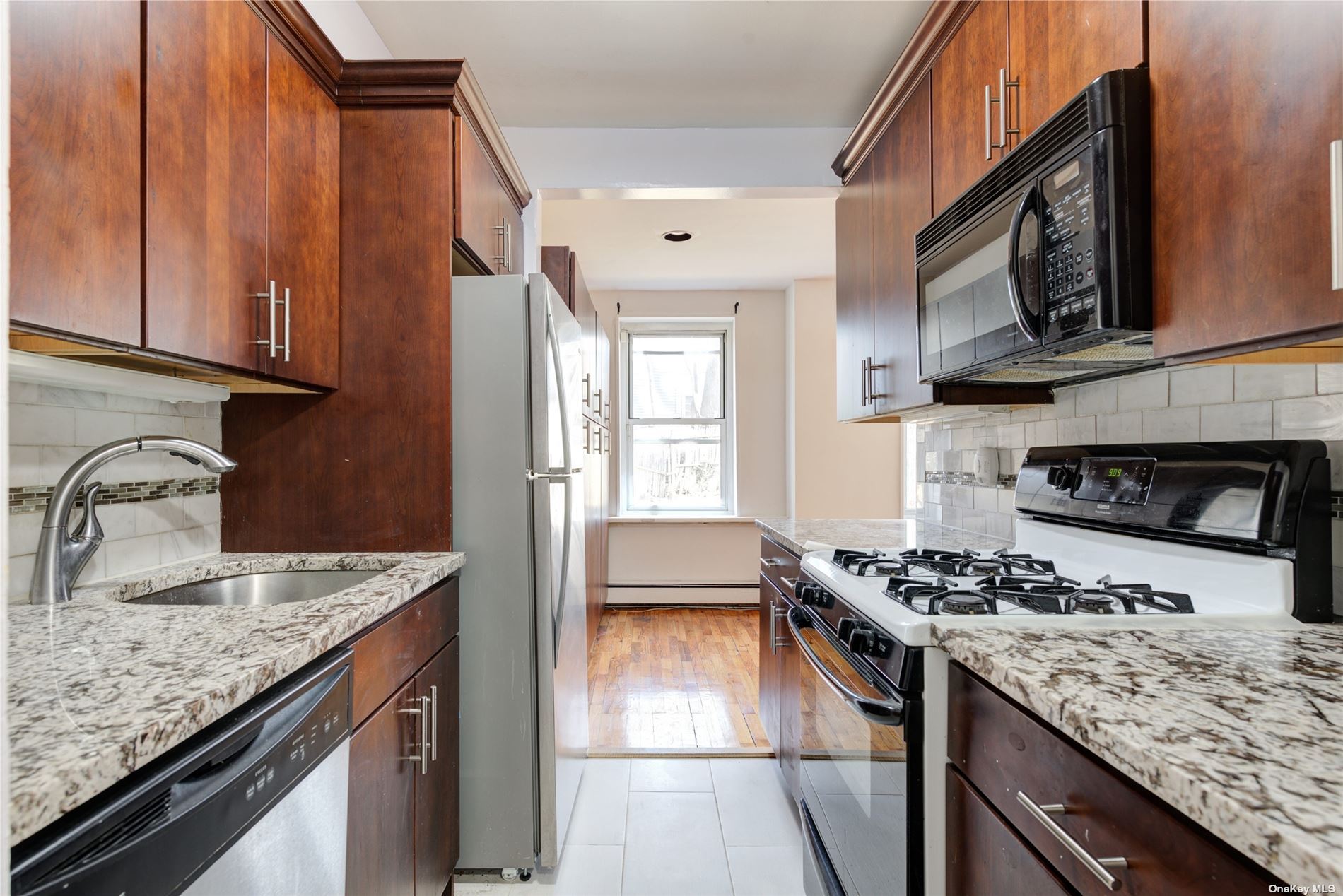 a kitchen with stainless steel appliances granite countertop a sink stove and cabinets