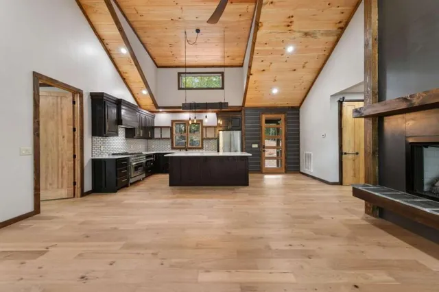 a view of a kitchen with a sink and an empty room