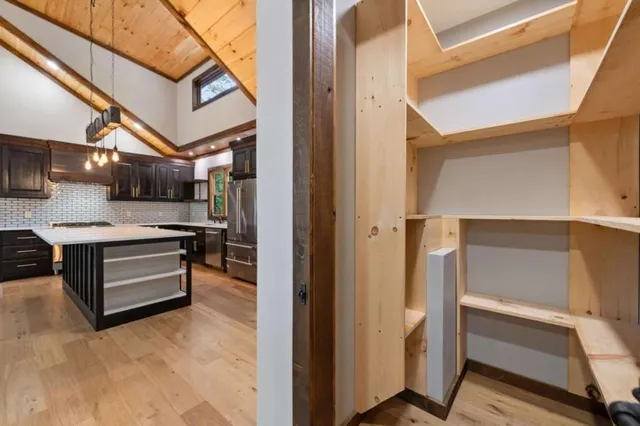 a view of kitchen with stainless steel appliances refrigerator and cabinets
