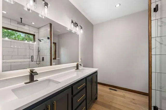 a bathroom with a sink double vanity and a mirror