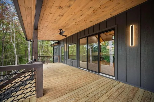 a balcony with wooden floor and outdoor space