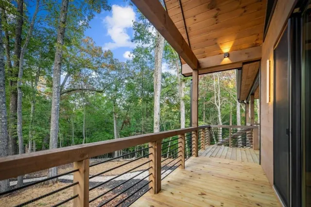 a view of balcony with wooden floor and fence