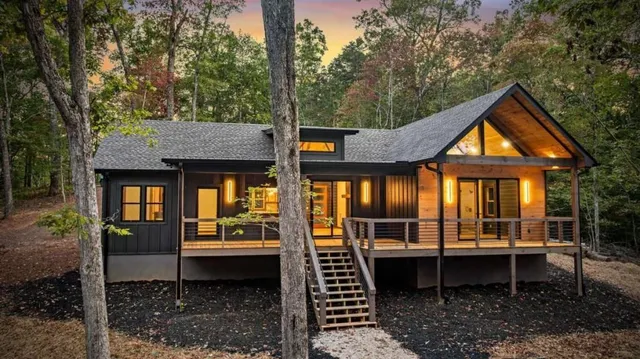 a backyard of a house with barbeque oven table and chairs