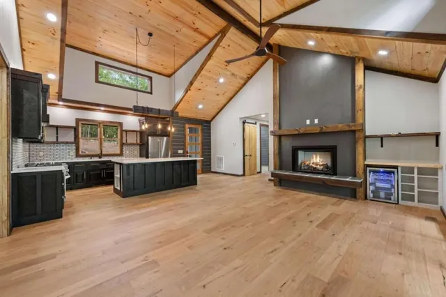 a view of a fireplace and kitchen in the background