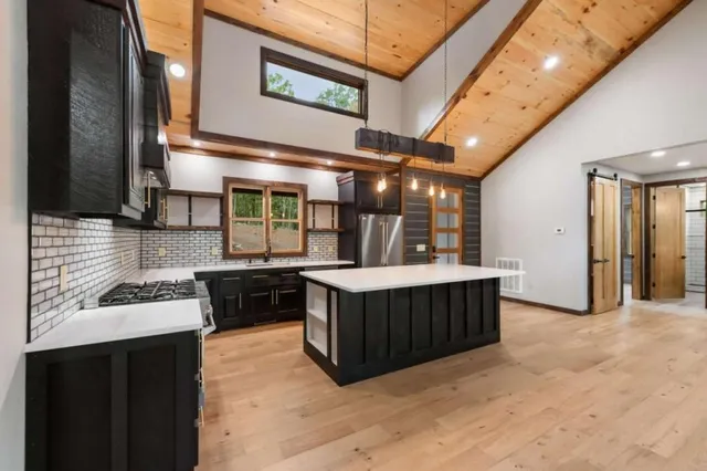 a kitchen with a stove a sink and a microwave