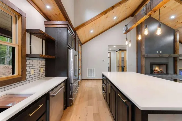 a open kitchen with a sink and refrigerator
