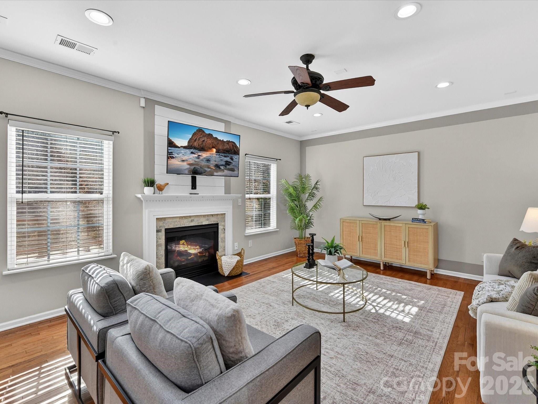 119 Edgington Street Mooresville, NC 28115 - Photo 12 of 43 a living room with furniture a fireplace with wooden floor