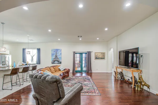 a kitchen with refrigerator and chairs