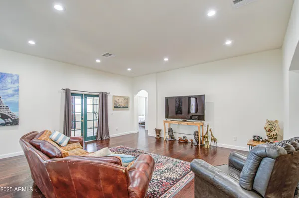 a bedroom with a bed rug and wooden floor