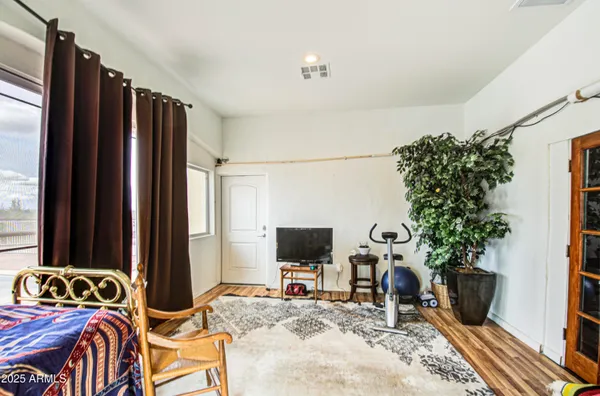 a bedroom with a bed and a flat screen tv