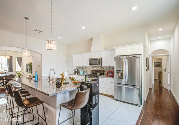 a bedroom with furniture and a flat screen tv