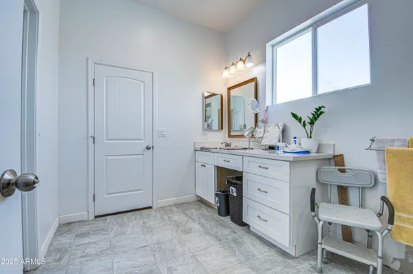 a bathroom with a sink toilet and a mirror