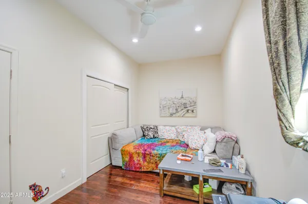 a living room with a table and chairs next to a window
