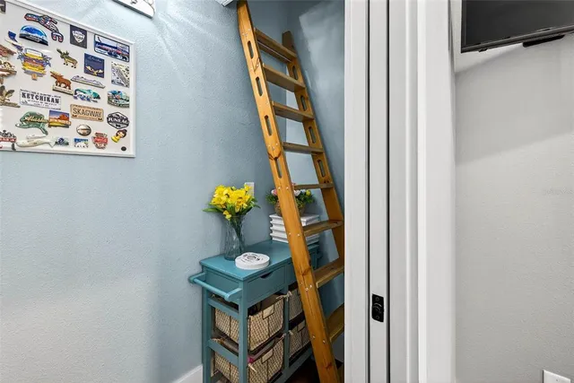 a kitchen with stainless steel appliances kitchen island granite countertop a table chairs in it and wooden floors