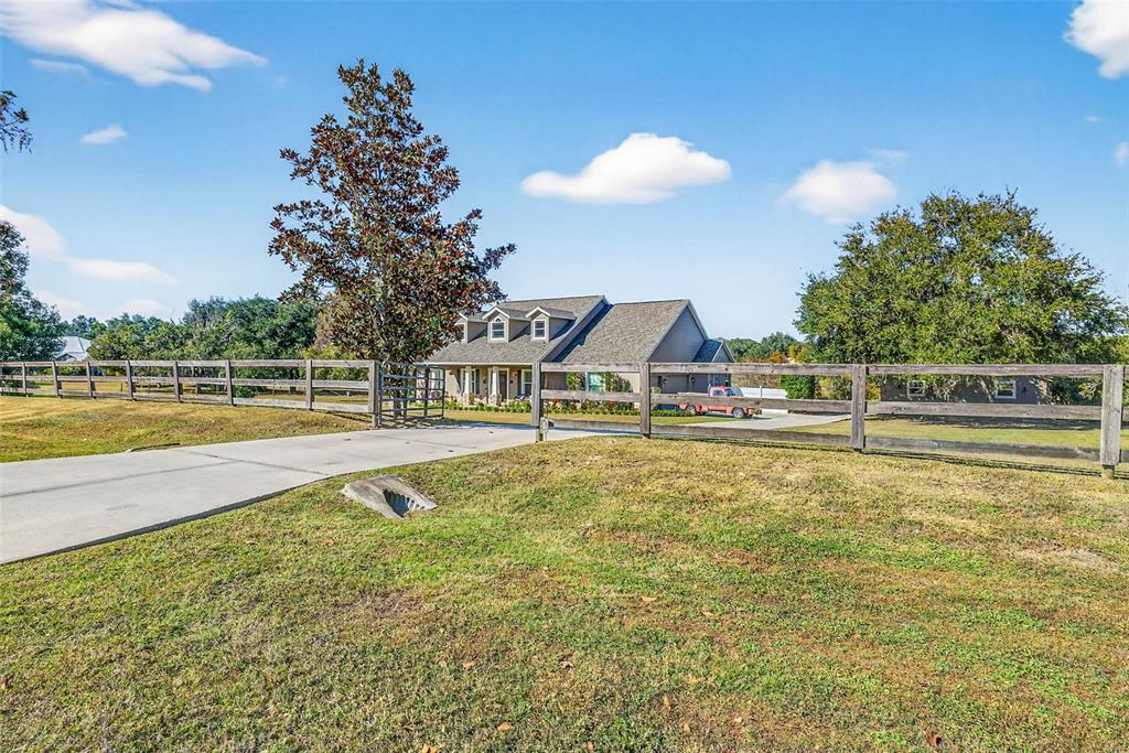 18051 Hancock Bluff Road Dade City, FL 33523 - Photo 2 of 98 a view of a swimming pool with an outdoor space and seating area