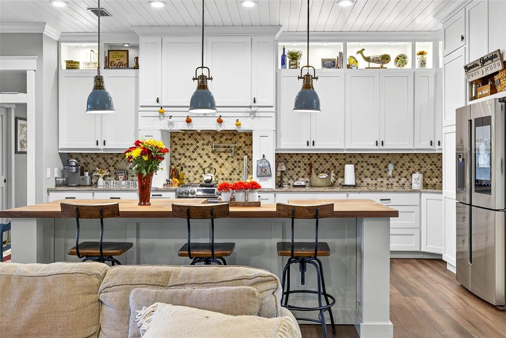 18051 Hancock Bluff Road Dade City, FL 33523 - Photo 26 of 98 a kitchen with stainless steel appliances kitchen island granite countertop a sink and cabinets