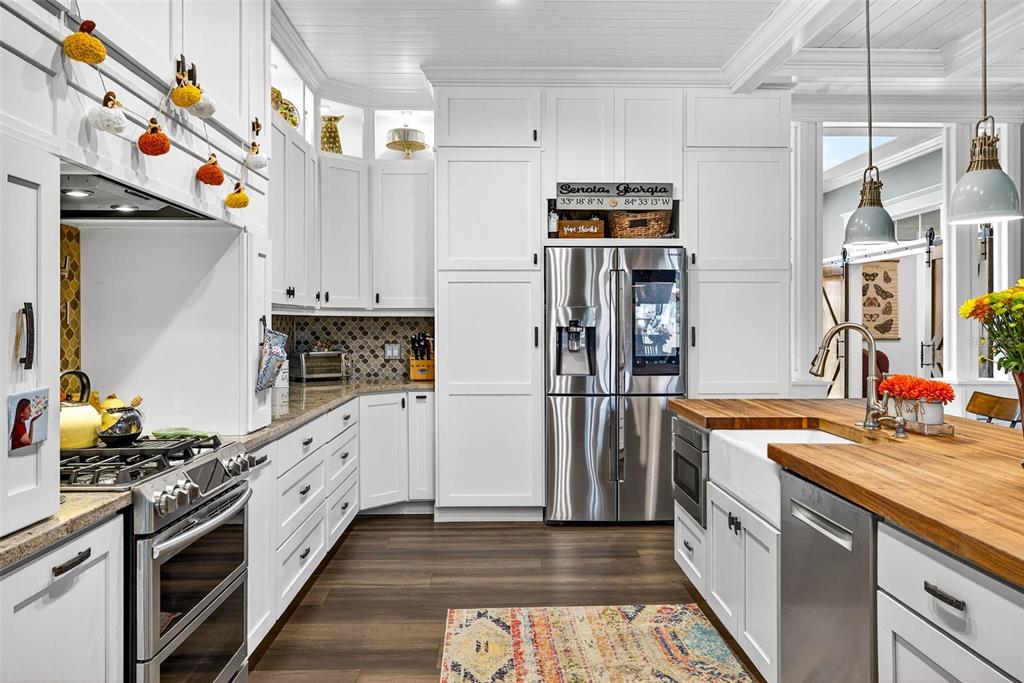 18051 Hancock Bluff Road Dade City, FL 33523 - Photo 32 of 98 a kitchen with stainless steel appliances granite countertop a refrigerator a stove and a sink