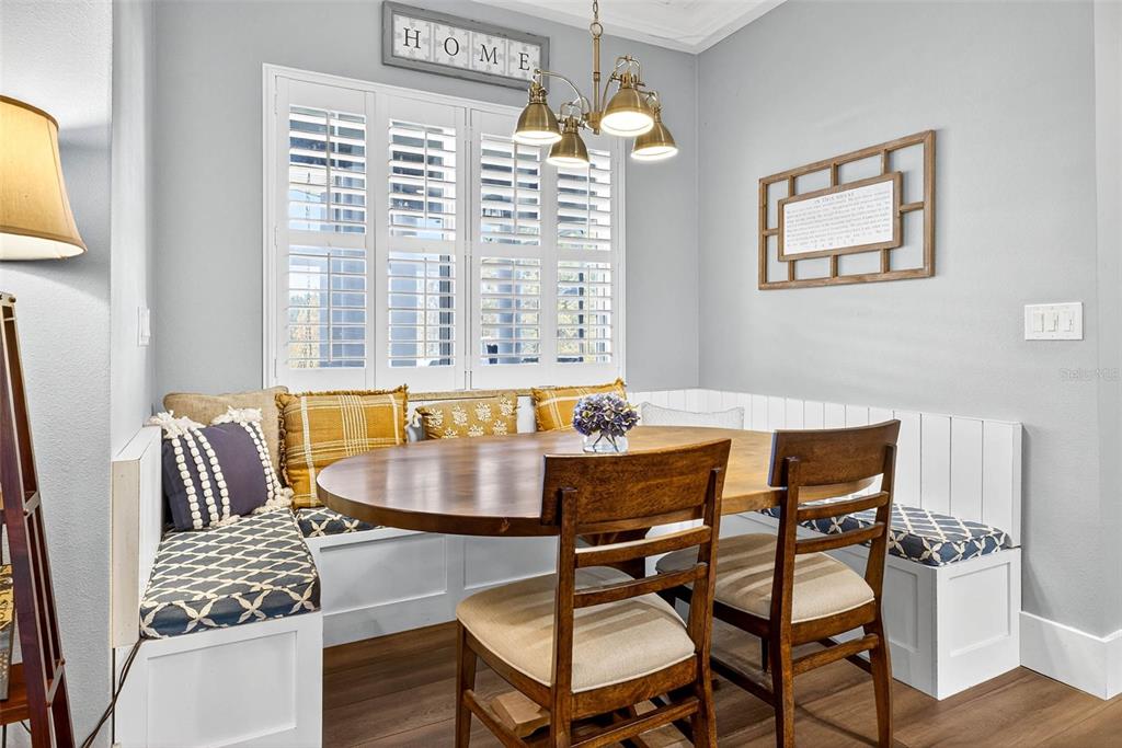 18051 Hancock Bluff Road Dade City, FL 33523 - Photo 37 of 98 a view of a dining room with furniture and wooden floor
