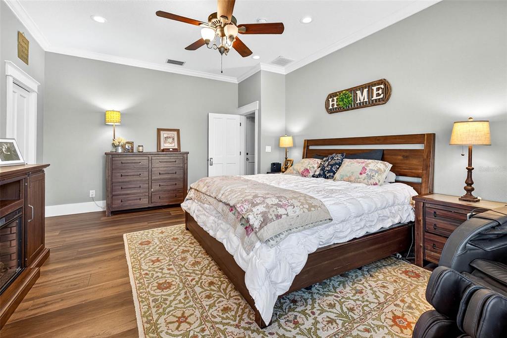 18051 Hancock Bluff Road Dade City, FL 33523 - Photo 52 of 98 a bedroom with a bed and wooden floor
