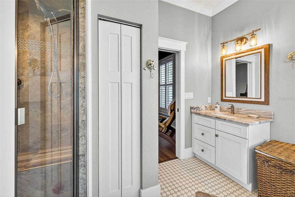 18051 Hancock Bluff Road Dade City, FL 33523 - Photo 56 of 98 a bathroom with a sink a mirror and a shower