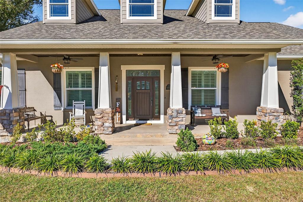 18051 Hancock Bluff Road Dade City, FL 33523 - Photo 7 of 98 a front view of a house with garden