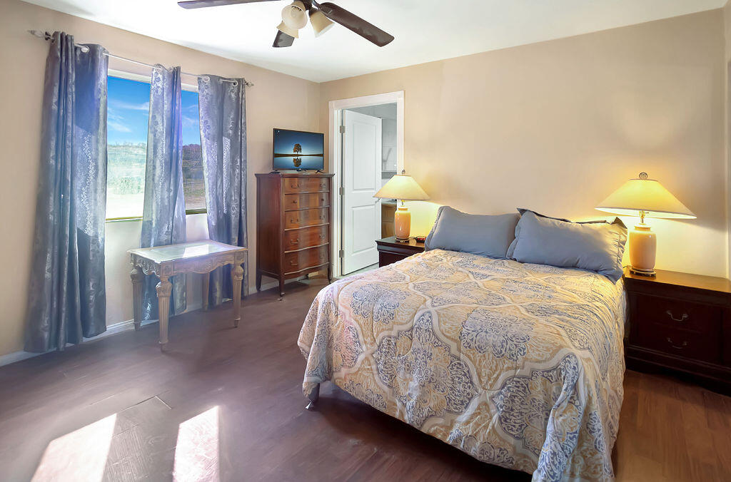 5134 Malin Way Yucca Valley, CA 92284 - Photo 15 of 27 a bedroom with a bed and a chandelier