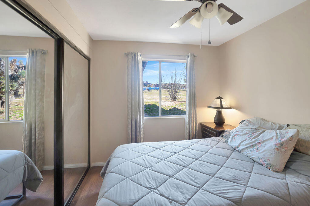 5134 Malin Way Yucca Valley, CA 92284 - Photo 19 of 27 a bedroom with a bed and a window