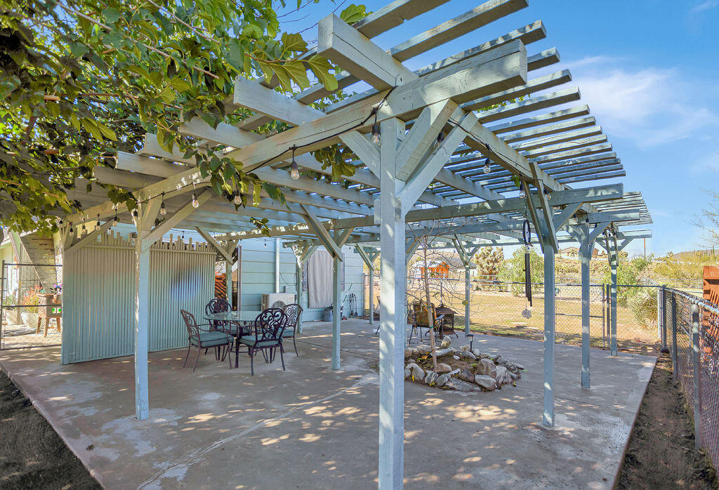 5134 Malin Way Yucca Valley, CA 92284 - Photo 23 of 27 a view of a porch with a table and chairs