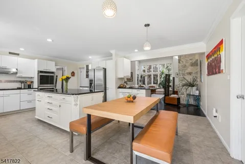 a large white kitchen with cabinets