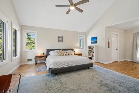 a living room with a bed furniture and next to a window