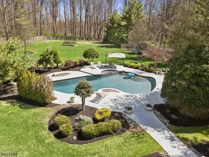 a view of a swimming pool with a yard