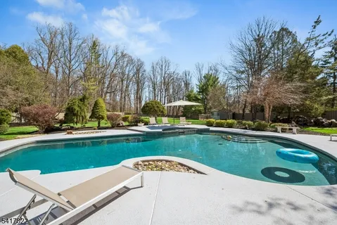 a view of a swimming pool and lounge chairs