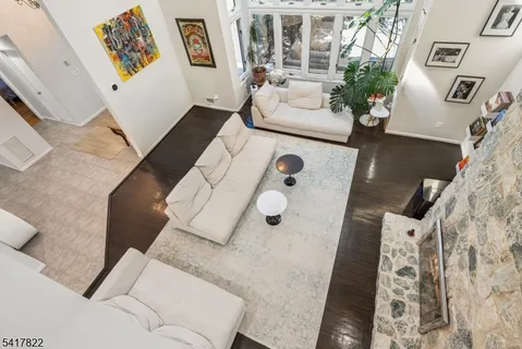 a living room with furniture and a floor to ceiling window
