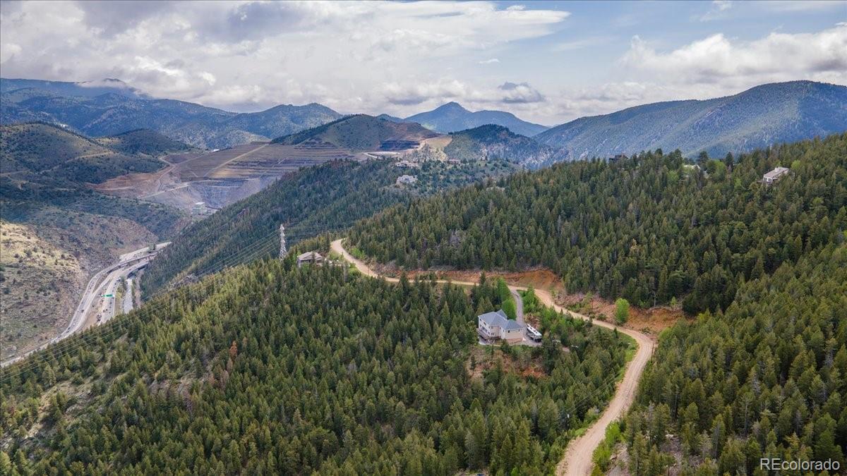 Clear Creek Road Evergreen, CO 80439 - Photo 16 of 26 a view of a house with a mountain in the background