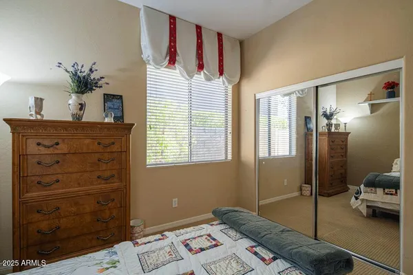 a bedroom with a bed and a potted plant