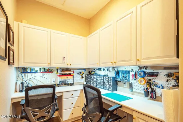 a kitchen with a chair and counter top space