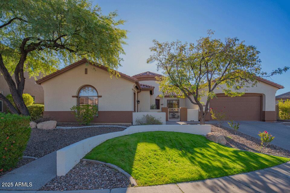 2347 West River Rock Court Phoenix, AZ 85086 - Photo 2 of 25 a front view of a house with garden