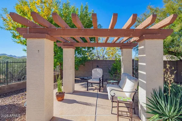 a patio with glass top table and chairs