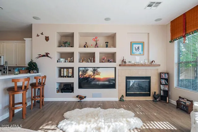 a living room with furniture and a fireplace