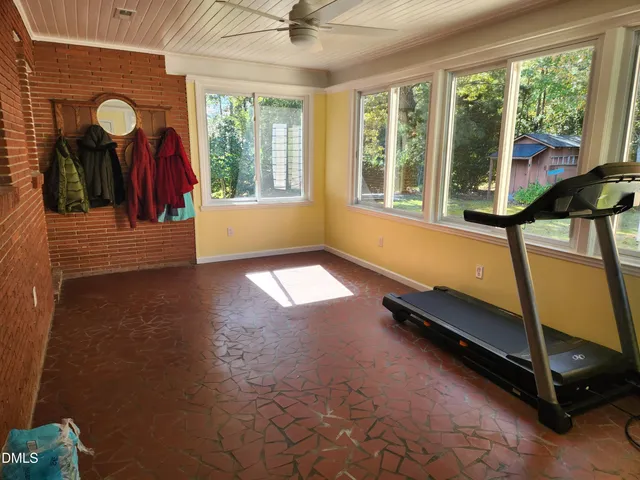 a view of hallway with furniture and a large window